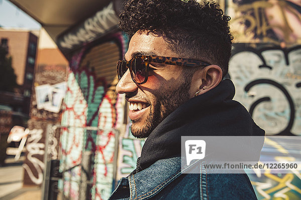 Portrait of smiling stylish young man outdoors