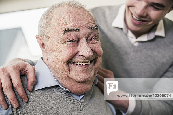 Portrait of happy senior man with young man