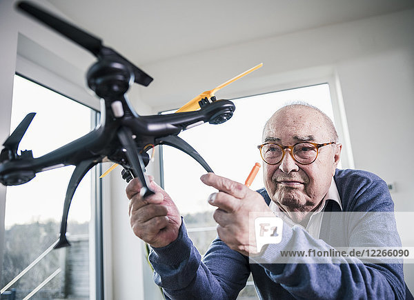 Portrait of senior man holding a drone