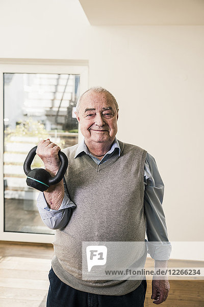 Portrait of smiling senior man doing a weight exercise