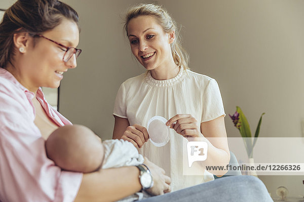Midwife holding a disposable nursing pad for breastfeeding mother