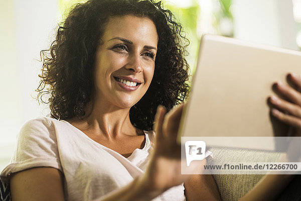 Portrait of smiling woman using tablet