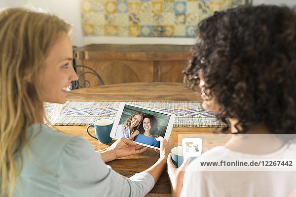 Two women looking at their picture on a tablet
