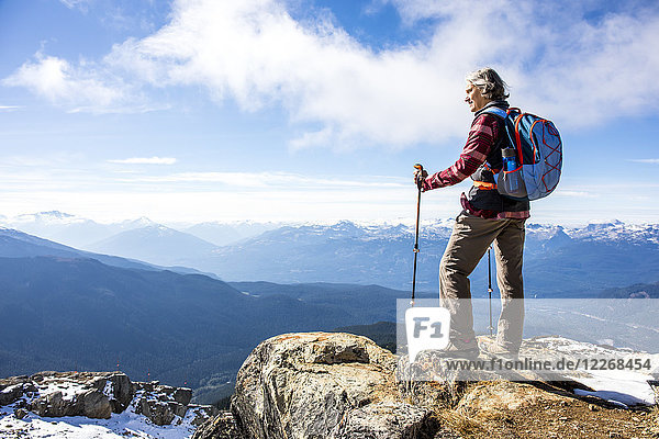 Female hiker looking at view of Garibaldi Provincial Park from top of Whistler Mountain  Whistler  British Columbia  Canada