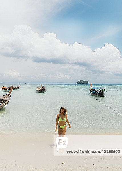 Attractive woman in bikini walking out of water onto beach sand  Tambon Ko Tarutao  Chang Wat Satun  Thailand