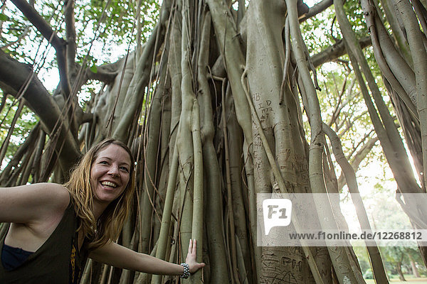 Woman standing near Indian banyan tree (Ficus benghalensis) at Durban Botanic Gardens in Durban  KwaZulu-Natal  South Africa