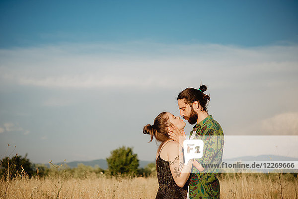Couple on golden grass field  Arezzo  Tuscany  Italy