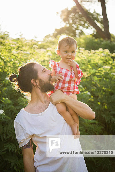 Man with baby girl in garden