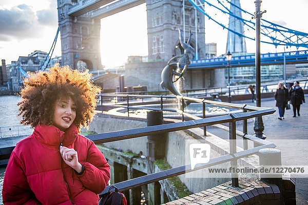 Portrait of young girl  outdoors  Tower Bridge in background  London  England  UK
