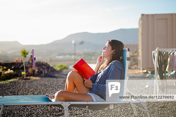 Woman on deckchair  journal in hand  Corralejo  Fuerteventura  Canary Islands