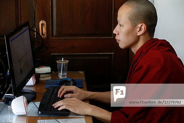 Monk using a computer in Wat Pan Sao.
