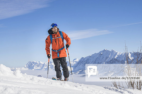 Skier climbing snow mountain in Upper Bavaria