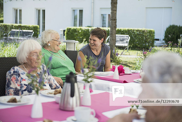 Senior women with nurse on breakfast table
