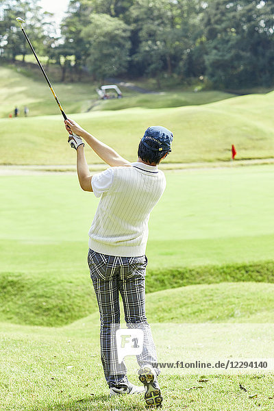 Japanese golf player on course