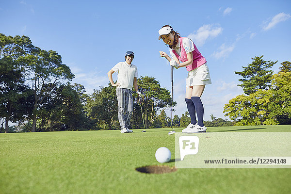 Japanese golf players on course