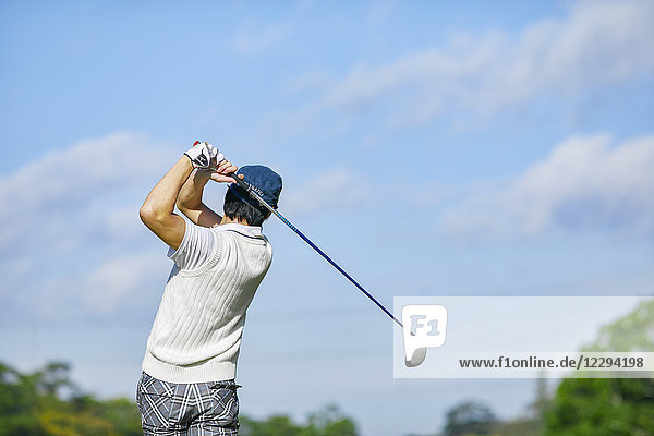Japanese golf player on course