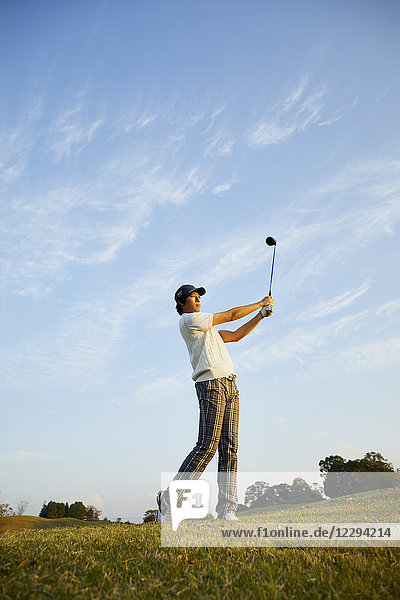 Japanese golf player on course