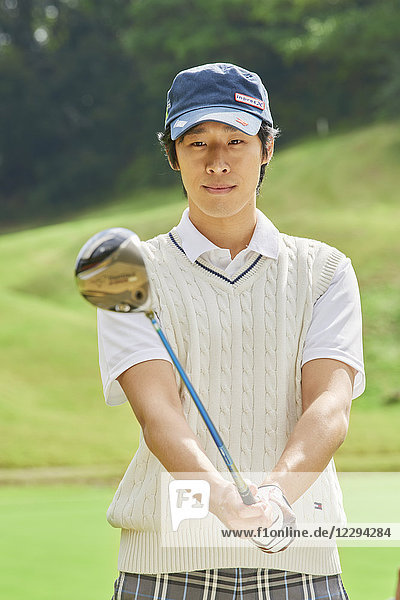 Japanese golf player on course