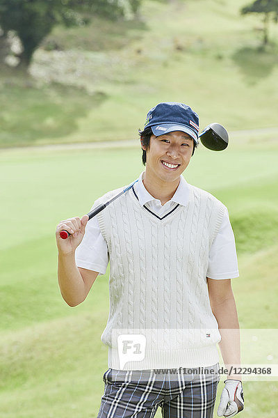 Japanese golf player on course