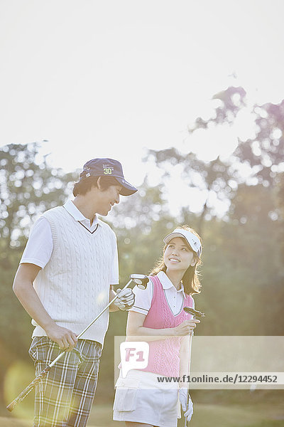 Japanese golf players on course