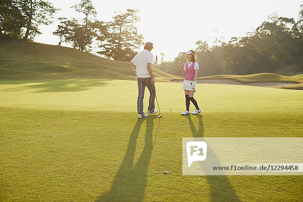 Japanese golf players on course