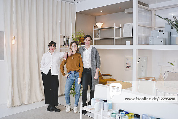 Full length portrait of female interior designers standing in store