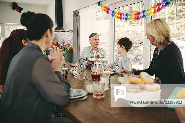 Family sitting at table during birthday party
