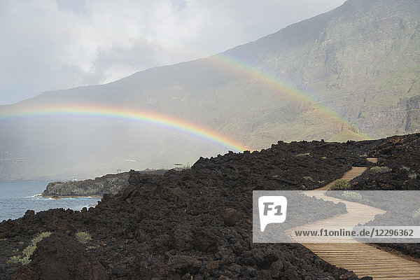 Scenic view of double rainbow over mountains and sea  Frontera  Island El Hierro  Spain