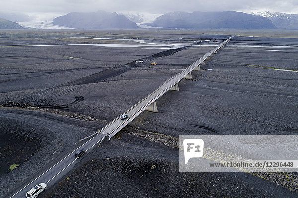 Aerial view of vehicles on bridge against mountains  Iceland