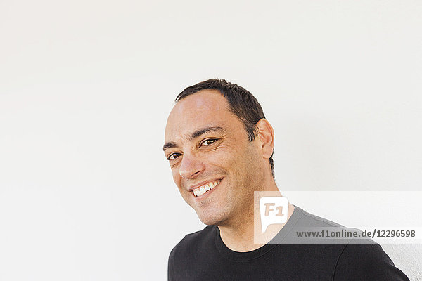 Portrait of cheerful man against white background