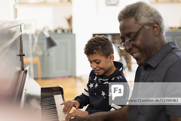 Grandfather and grandson playing piano