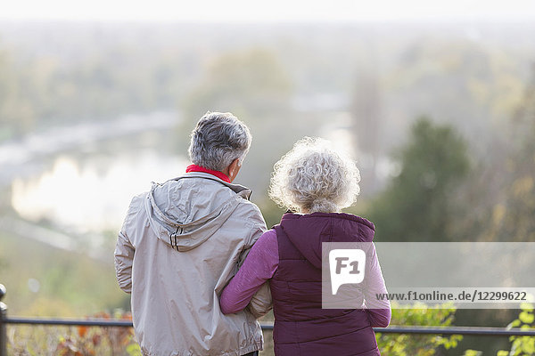 Active senior couple looking at view in nature