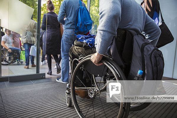 Man in wheelchair leaving office