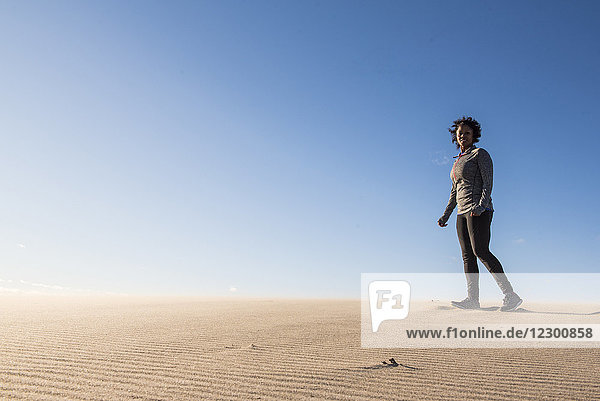 Junge Frau  die am Sandstrand gegen den klaren Himmel läuft  Newburyport  Massachusetts  USA