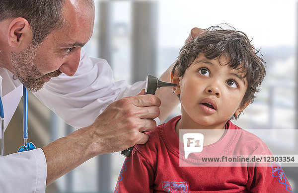 Doctor examining a child's ear.