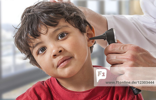 Doctor examining a child's ear.