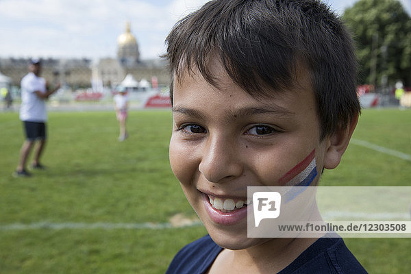Lächelnder 11-jähriger Junge mit einer Tätowierung der französischen Flagge. Paris  Frankreich.