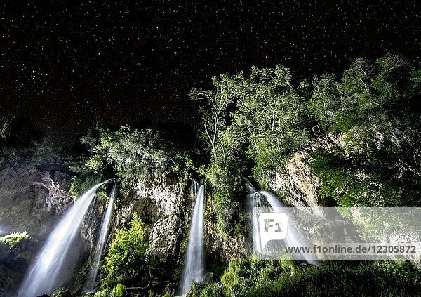 Sternenklarer Nachthimmel über einem beleuchteten Wasserfall im Rifle Falls State Park  Colorado  USA