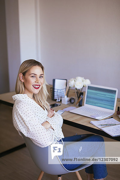 Blond businesswoman sitting at desk  working