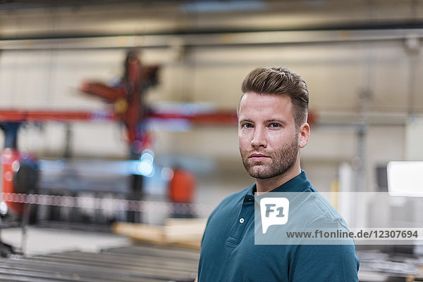 Portrait of confident man on factory shop floor