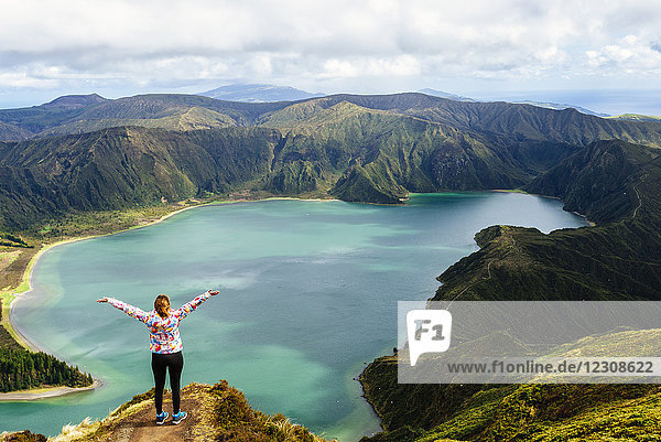 Azores  Sao Miguel  Woman with raised arms on the top of the Lagoa do Fogo