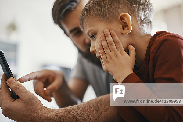 Father and little son with smartphone