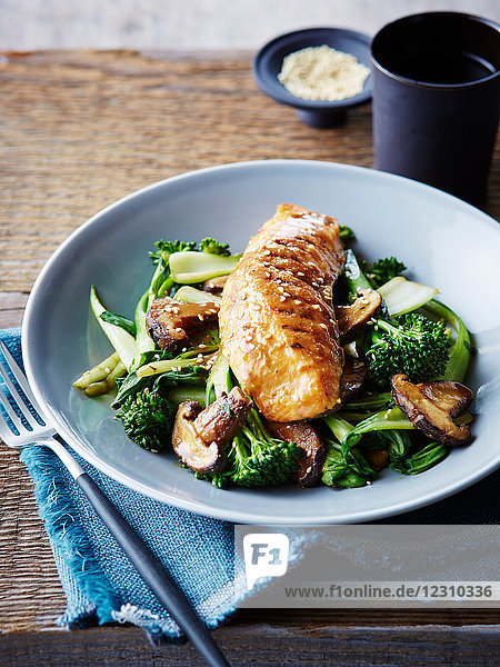 Miso and maple glazed salmon on stir fried asian greens  close-up