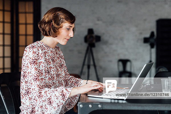 Woman at desk using laptop