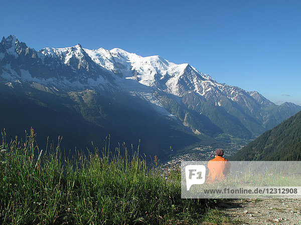 Haute Savoie  Tour du mont blanc  ein Mann genießt die Aussicht oberhalb von Chamonix auf den Mont blanc von La Flegere aus
