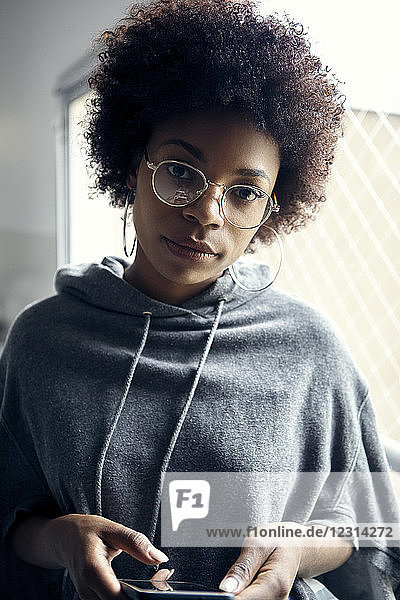 Young woman holding smartphone  portrait