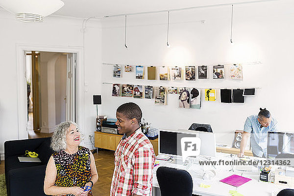 Coworkers talking in office