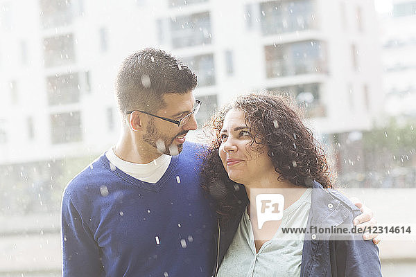 Portrait of mid adult couple standing in rain