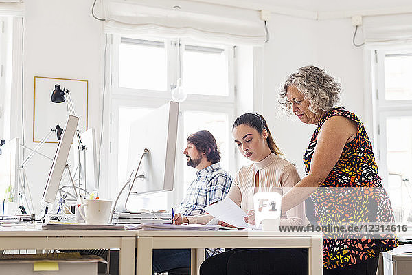 Colleagues working together in office