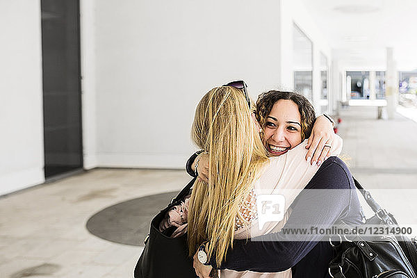 Young women hugging each other